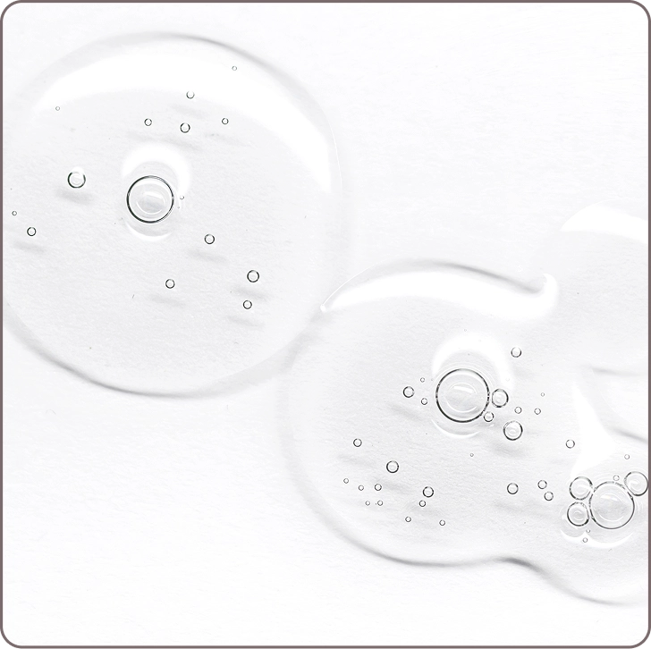 Macro image of clear serum drops showing hyaluronic acid’s moisturizing effect for supple, hydrated skin.