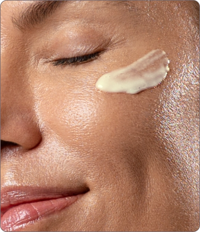 Close-up of woman applying Repair Serum, with visible glow and hydration